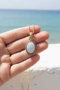 Moonstone necklace hand shot beach